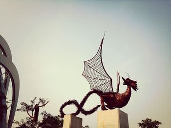 Low angle view of statue against sky