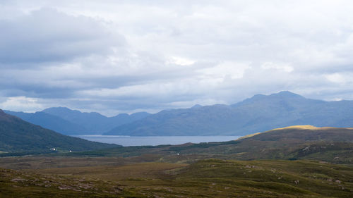 Scenic view of mountains against cloudy sky