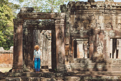 Mid adult woman standing in historic building