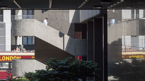 Man standing by building in city