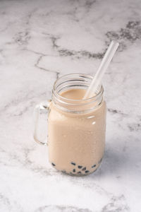 Close-up of drink in glass jar on table