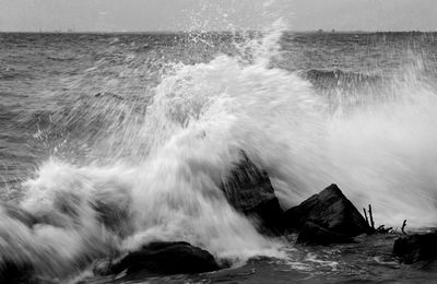 Waves splashing on rocks at shore