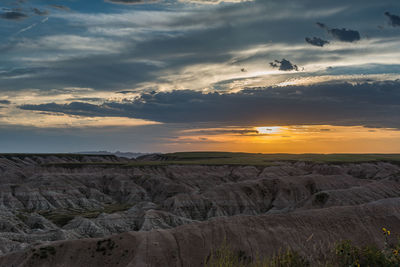 Scenic view of mountains against cloudy sky at badlands national park