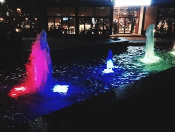 Illuminated fountain at night