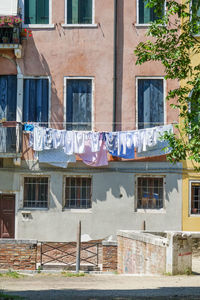 Clothes drying against buildings in city