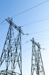 Low angle view of electricity pylon against sky