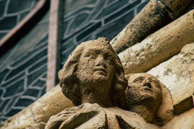 Low angle view of statue against brick wall