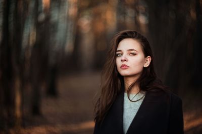 Portrait of a beautiful young woman in forest