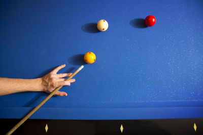 Low angle view of person playing with ball on table