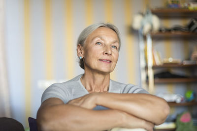 Portrait of smiling senior woman relaxing at home