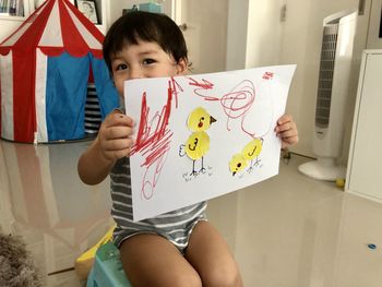 A boy showing off his artwork