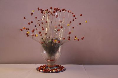 Close-up of wine glass on table against wall
