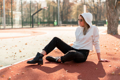 Young woman sitting on floor