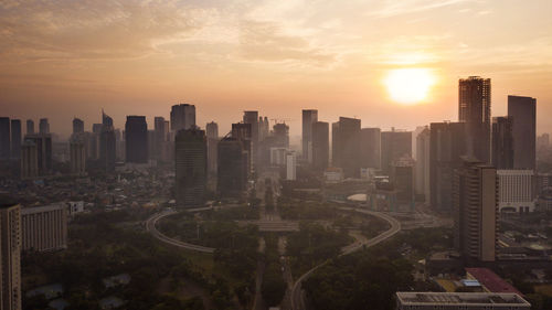 High angle view of buildings in city against sky during sunset