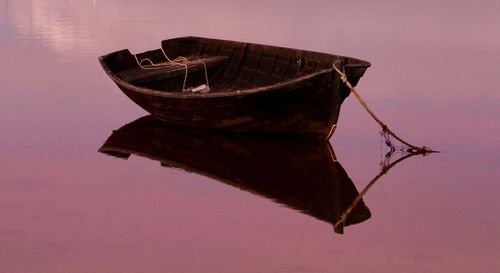 Abandoned boat in lake against sky