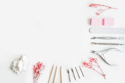 High angle view of pink roses on white table