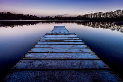 Pier over lake against sky