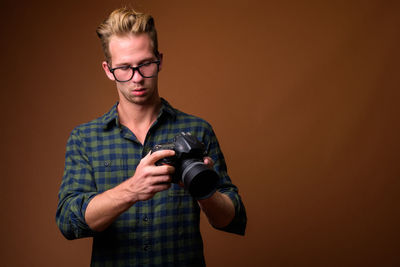 Portrait of young man photographing