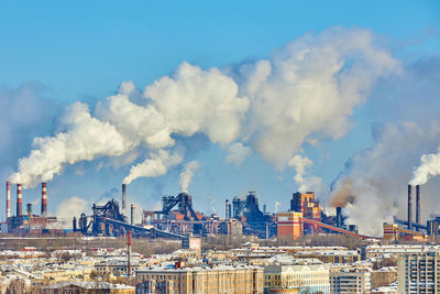 Smoke emitting from chimney against sky