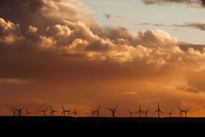 Picturesque scenery of windmill farm under spectacular cloudy sky during sundown in patagonia