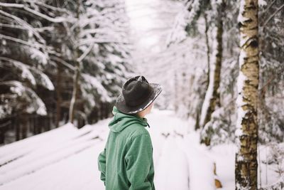 Woman standing on snow covered landscape