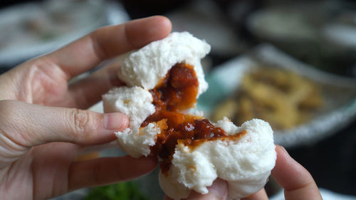 Hands open hot chinese pork bbq bun dim sum bun before eating