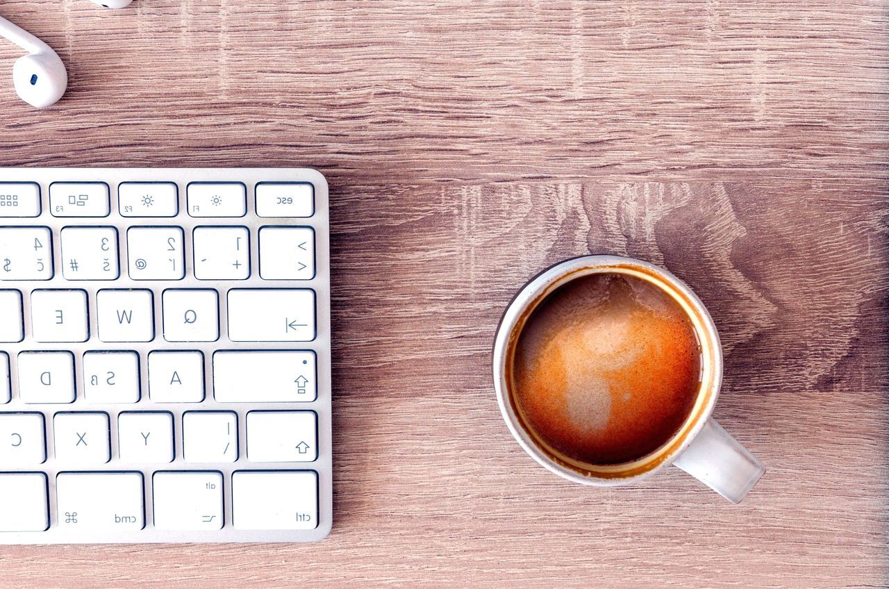 HIGH ANGLE VIEW OF COFFEE CUP ON TABLE AT HOME