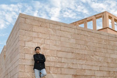 Confident transgender person looking at camera while posing outdoors.