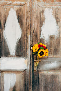 Close-up of yellow flower vase against wall