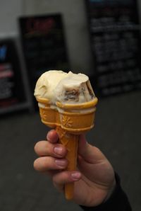 Close-up of hand holding ice cream