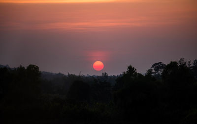 Scenic view of silhouette trees against sky during sunset