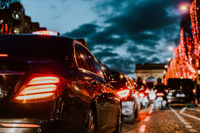 Close-up of illuminated city against sky at night