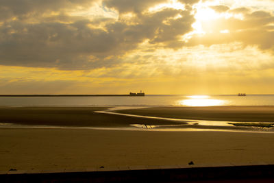Scenic view of beach against sky during sunset