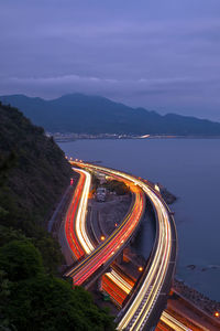 High angle view of light trails on road against sky at night