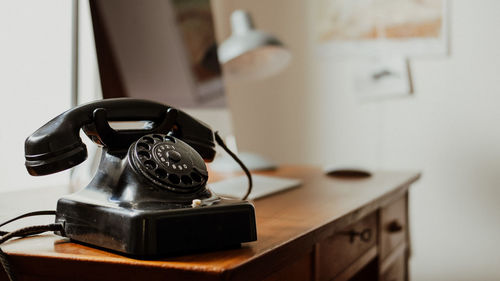 Close-up of old telephone on table