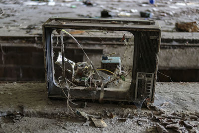 Close-up of rusty abandoned on field