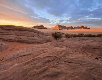 Scenic view of desert against sky during sunset