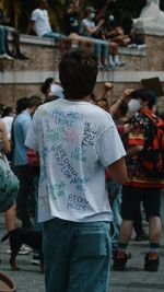 Rear view of people standing on street