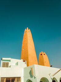 Low angle view of building against clear blue sky