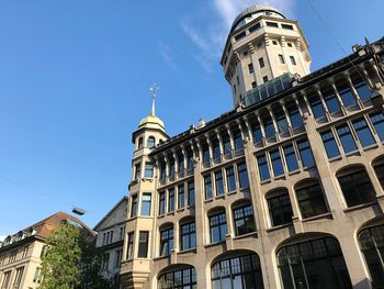 Low angle view of buildings against blue sky