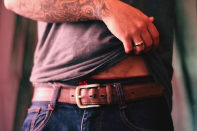 Midsection of man holding camera