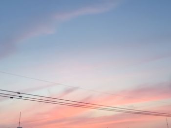 Low angle view of electricity pylon against sky