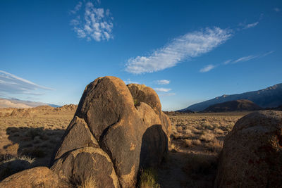 Rock formations on land against blue sky