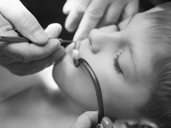 Close-up of dentist examining teeth of boy at clinic