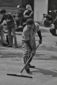 Man cleaning road in city