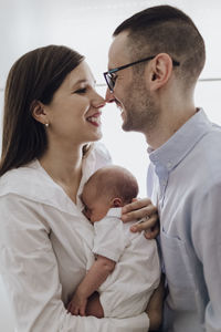 Side view of senior couple kissing at home