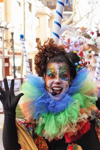 Portrait of happy mid adult woman in face paint standing outdoors