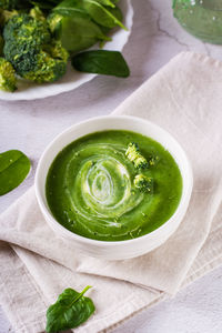 Bowl with broccoli cream soup on the table. healthy food. vertical view