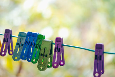 Close-up of clothespins hanging on clothesline