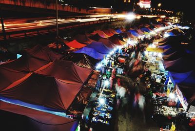 Crowd at illuminated city at night